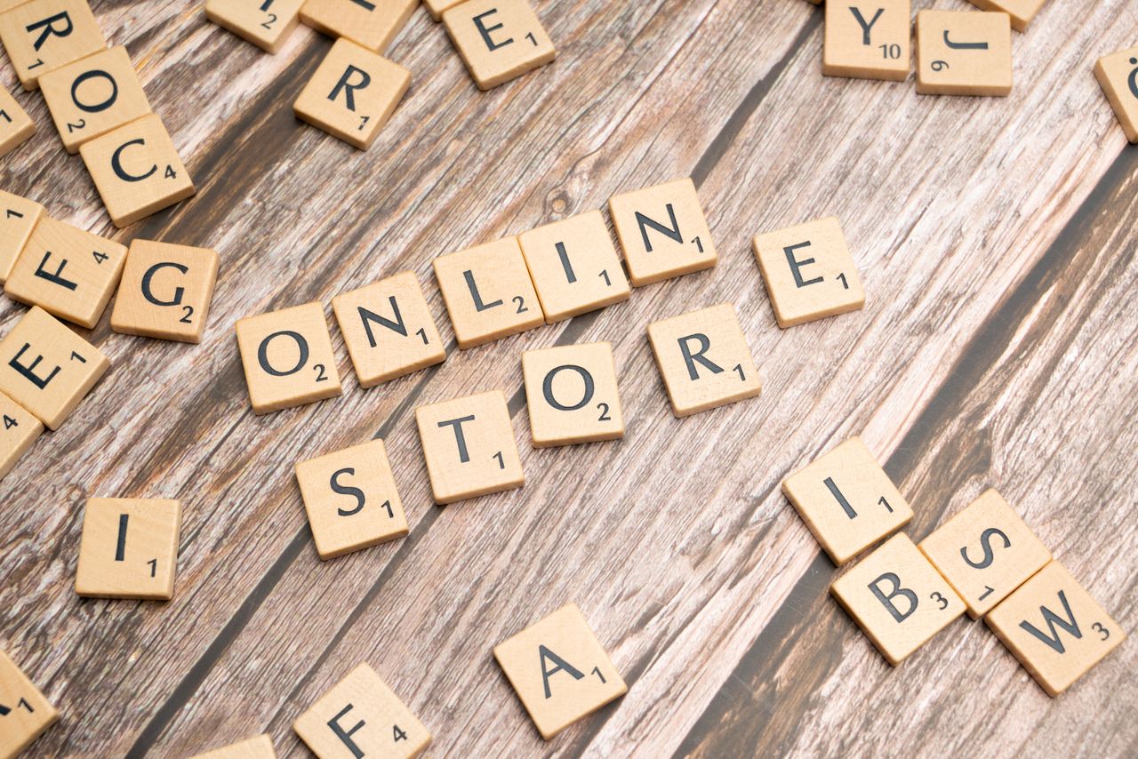 about-02 Scrabble tiles spelling 'online store' on a rustic wooden background.
